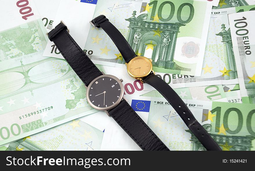 Time is money concept photo: two watches on 100 euro banknotes background. Time is money concept photo: two watches on 100 euro banknotes background