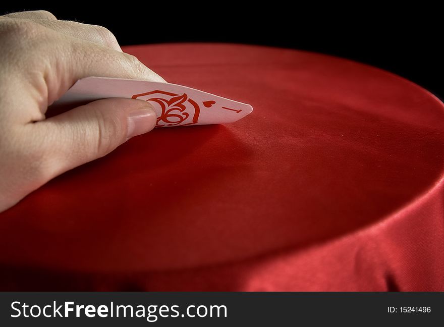 Player hold poker cards. The vintage poker cards on red table
