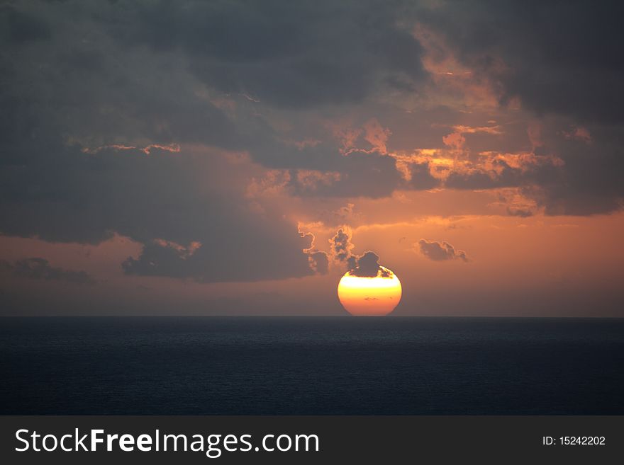 The sun sets over the Mediterranean with a look reminiscent of cooling molten iron. The sun sets over the Mediterranean with a look reminiscent of cooling molten iron