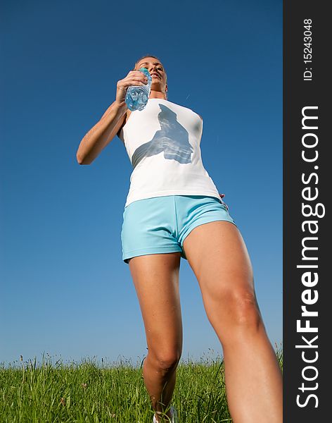 Young woman is doing fitness exercise in the nature. Young woman is doing fitness exercise in the nature