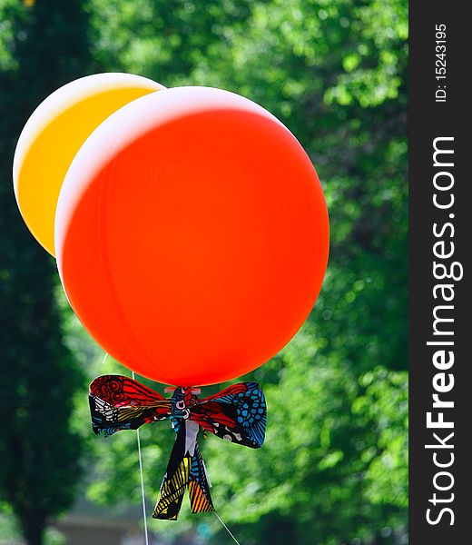 Red and yellow balloons on green background