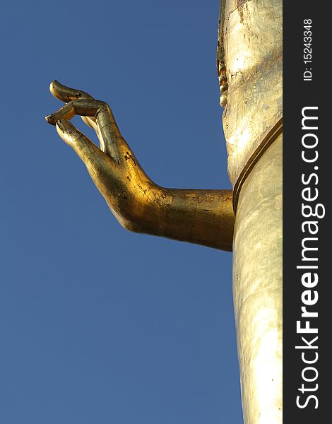 Golden Hand of Buddha whit blue sky