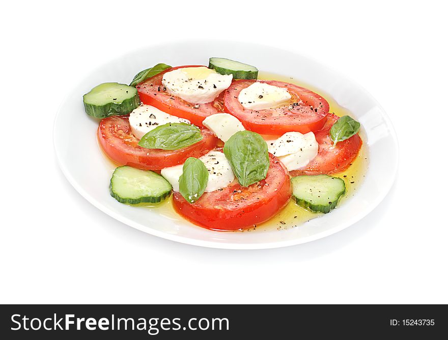 Fresh mozzarella cheese balls paired with tomato cucumber and basil in this italian classic on white background. Fresh mozzarella cheese balls paired with tomato cucumber and basil in this italian classic on white background