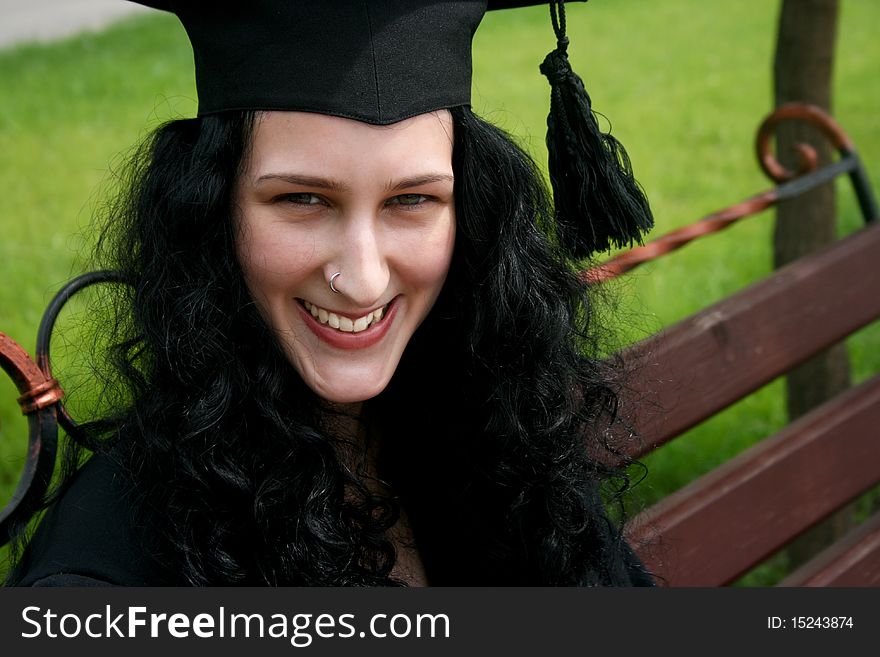 Smiling caucasian student sitting on the bench