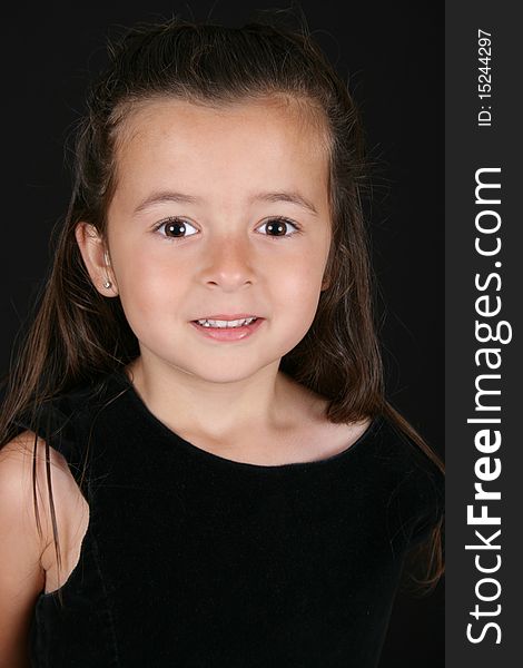 Cute little brunette girl against a black background. Cute little brunette girl against a black background