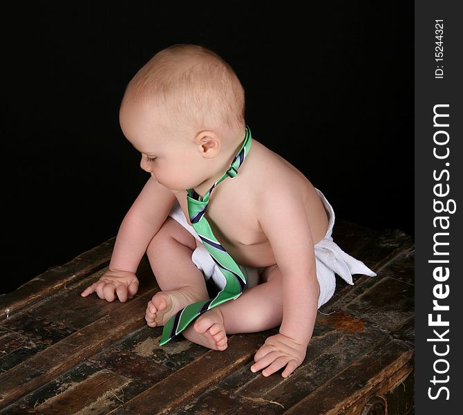 Cute caucasian baby wearing just a tie and diaper. Cute caucasian baby wearing just a tie and diaper