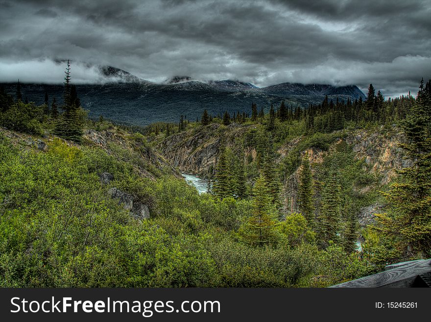 HDR image obtained from the White Pass in the Yukon near the suspension bridge of the Tutshi River Canyon near the South Klondike Highway. HDR image obtained from the White Pass in the Yukon near the suspension bridge of the Tutshi River Canyon near the South Klondike Highway.