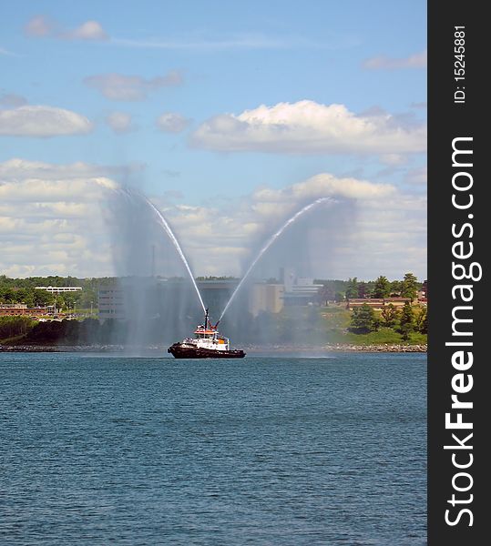 A tug boat spraying its jets in Halifax Harbor. A tug boat spraying its jets in Halifax Harbor.