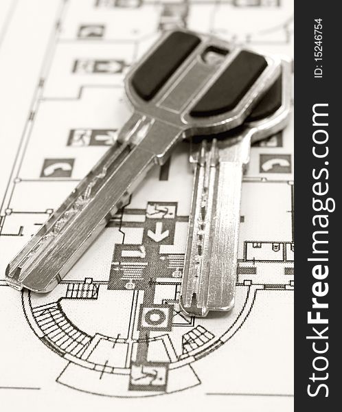 Two keys are shown on the background of an emergency exit plan. Two keys are shown on the background of an emergency exit plan