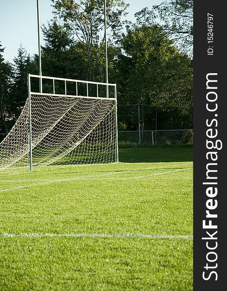 Empty white soccer net on grass field. Empty white soccer net on grass field
