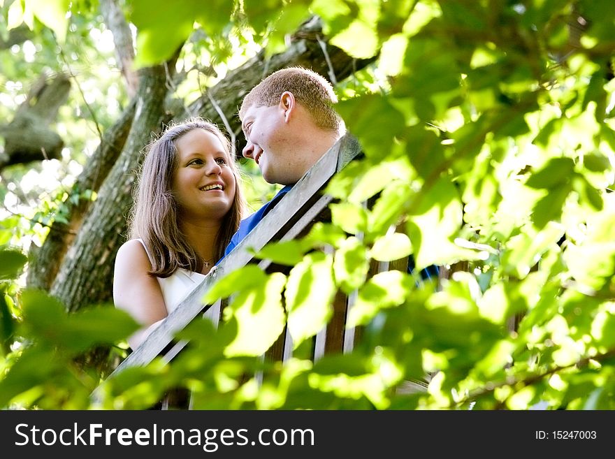 A couple in love series shot in the woods. This image shows the couple in a leaf framed border. The leaves in the foreground are slightly out of focus. Please check out the other image with the couple slightly defocused for a little different spin on the situation. A couple in love series shot in the woods. This image shows the couple in a leaf framed border. The leaves in the foreground are slightly out of focus. Please check out the other image with the couple slightly defocused for a little different spin on the situation.