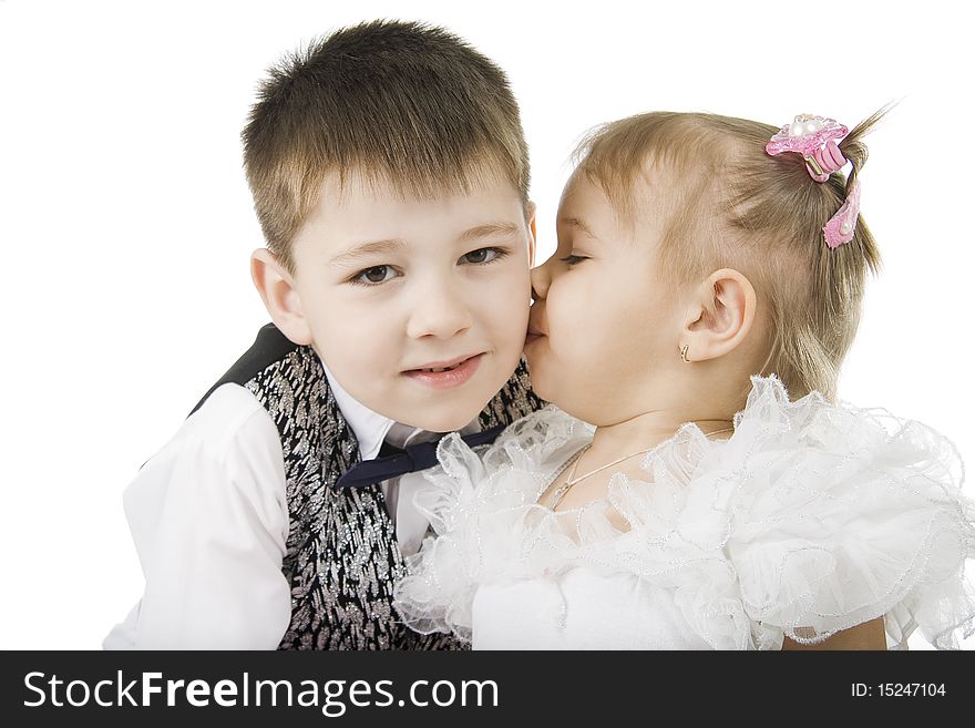 The little girl kisses the brother on a white background. The little girl kisses the brother on a white background.