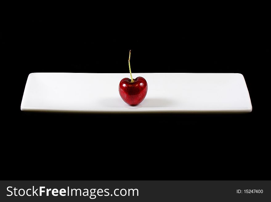 Cherry on white plate