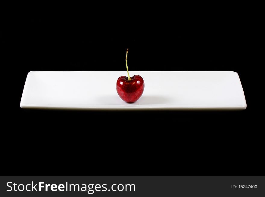 Heart shape cherry against black background. Heart shape cherry against black background