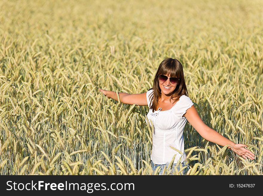 Happy young woman in corn field enjoy sunset