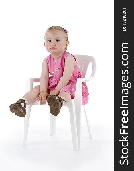 Toddler on stool on white background.