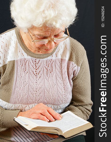 Elderly woman studying the Bible