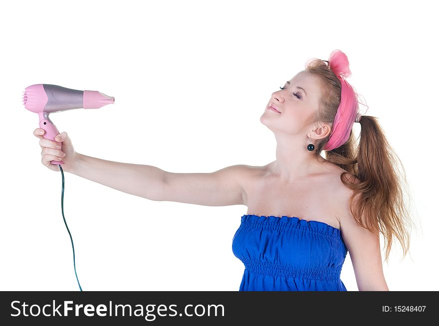Red-haired girl with the hair dryer. Isolated over white .
