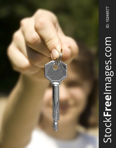 And holds a key (key in focus)