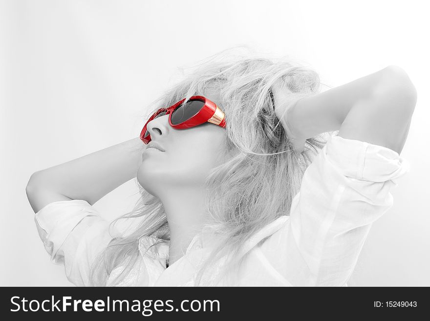 The beautiful woman. Disheveled hair. Red glasses