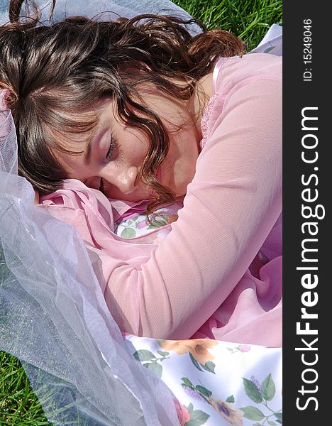 A young girl sleeps on a grass. A young girl sleeps on a grass