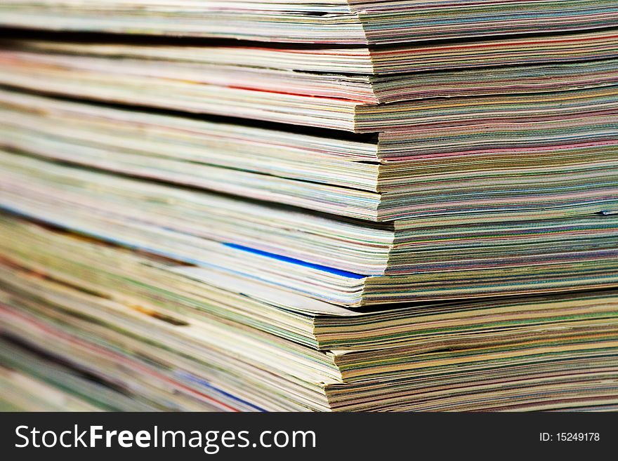 Close up of a lot of piled magazines, focus on the right side. Close up of a lot of piled magazines, focus on the right side