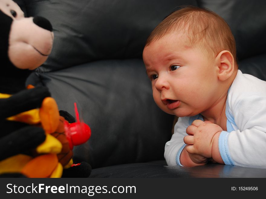 Relaxing small baby-boy with a toy