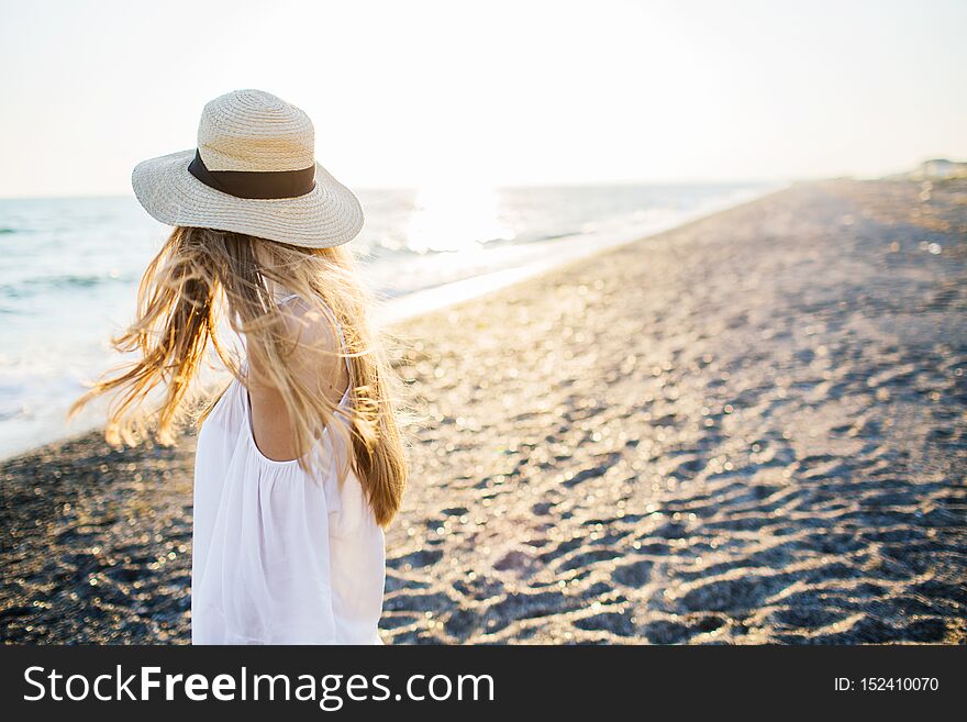 Young attractive long haired girl at the beach.