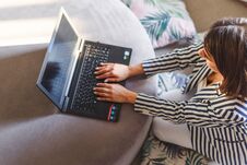 Top View Of Young Woman Sitting On Floor With Laptop Stock Photos