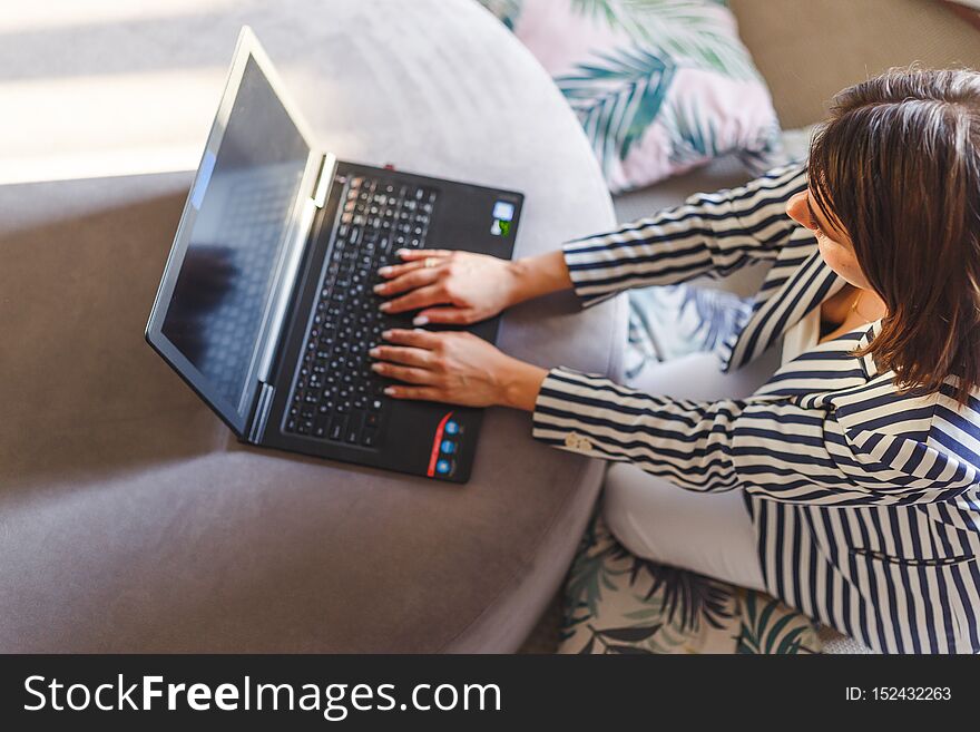 Top View Of Young Woman Sitting On Floor With Laptop