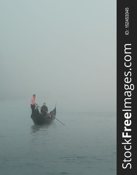 a foggy morning in venice and a lonely gondola on the canal. a foggy morning in venice and a lonely gondola on the canal.