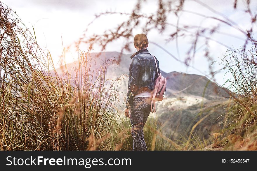 Woman standing on mountain in morning. Bali island. Indonesia. Woman standing on mountain in morning. Bali island. Indonesia.