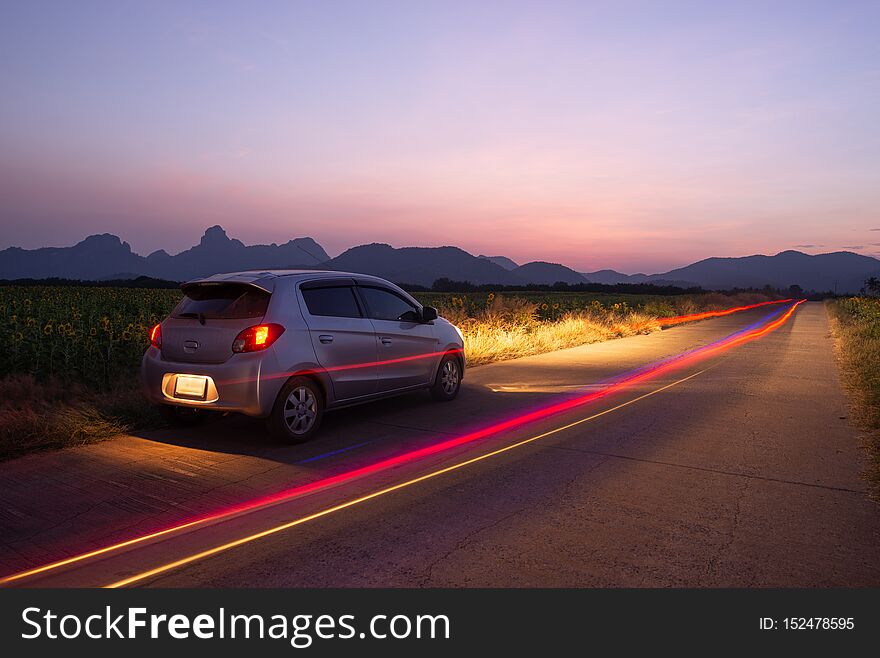 Travel car is parking at the road country side with landscape view beautiful sunset