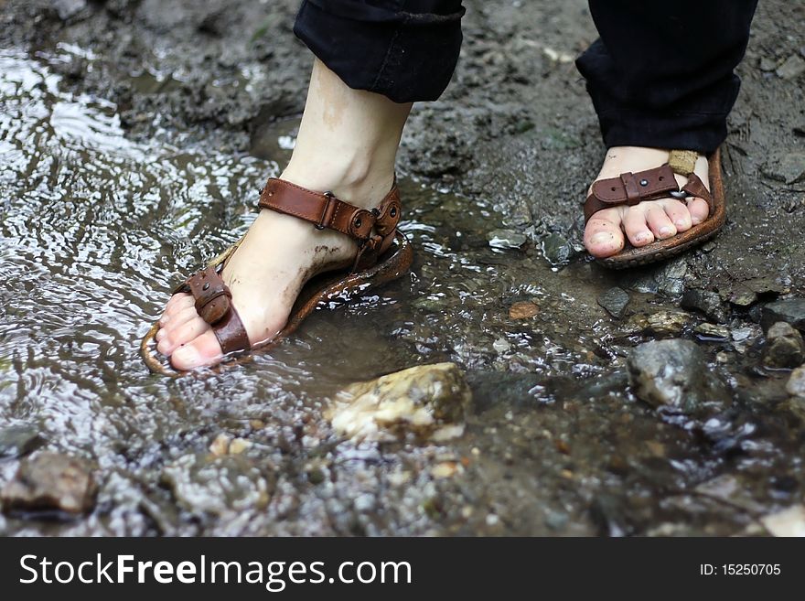 Girl washing her shoes in the water. Girl washing her shoes in the water