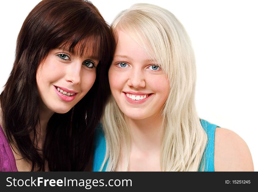 Two cute girls,  one brunette and one blond, smiling for a portrait, isolated on white. Two cute girls,  one brunette and one blond, smiling for a portrait, isolated on white