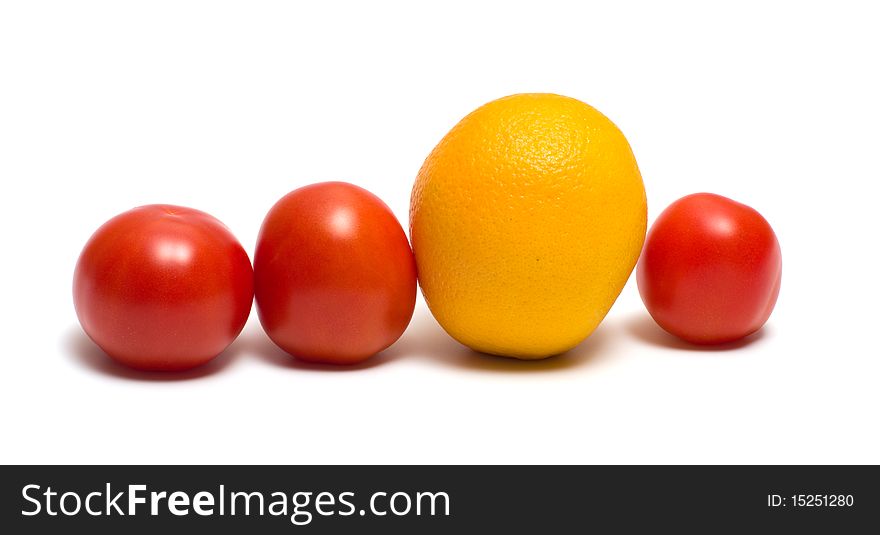 Three red tomatoes and yellow orange on a white background. Three red tomatoes and yellow orange on a white background.