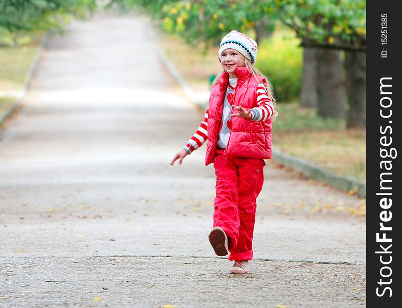 Young happy girl walking in autumn park. Young happy girl walking in autumn park