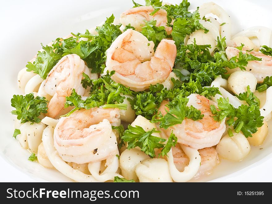 Cooked shrimps, squid and baby scallops garnished with parsley and freshly ground pepper. Cooked shrimps, squid and baby scallops garnished with parsley and freshly ground pepper.