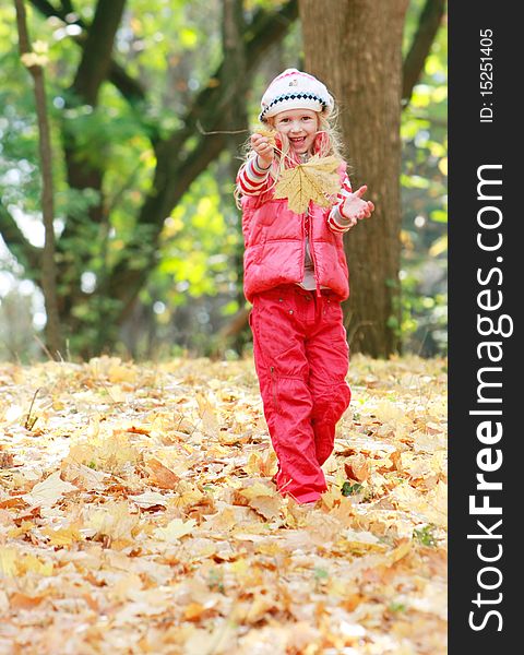 Young happy girl playing in autumn park. Young happy girl playing in autumn park