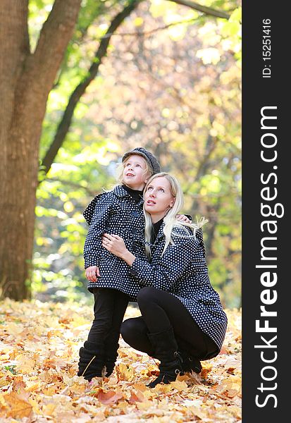 Mother and daughter in autumn park. Mother and daughter in autumn park