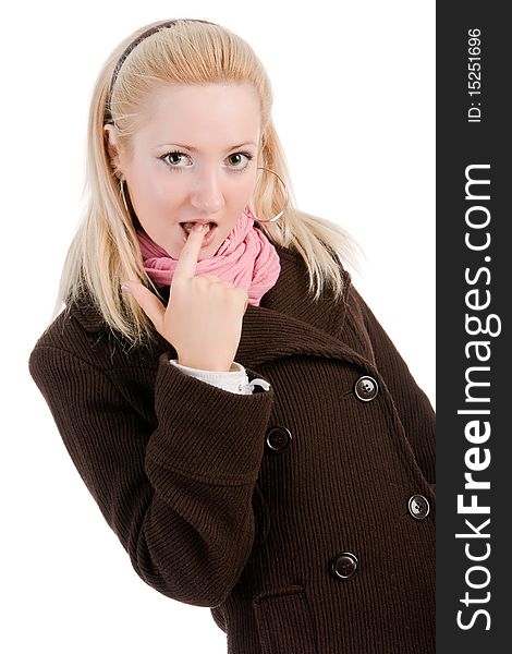 Portrait of a shy blond young girl in coat with finger in mouth