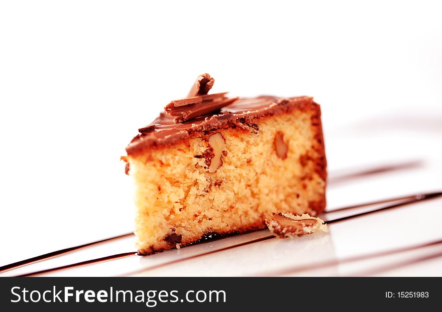 Slice of chocolate glazed nut cake - closeup. Slice of chocolate glazed nut cake - closeup