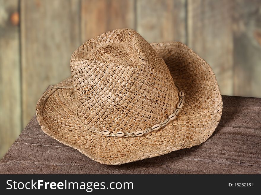 Detailed image of a cowboy hat set against a wood fence,. Detailed image of a cowboy hat set against a wood fence,