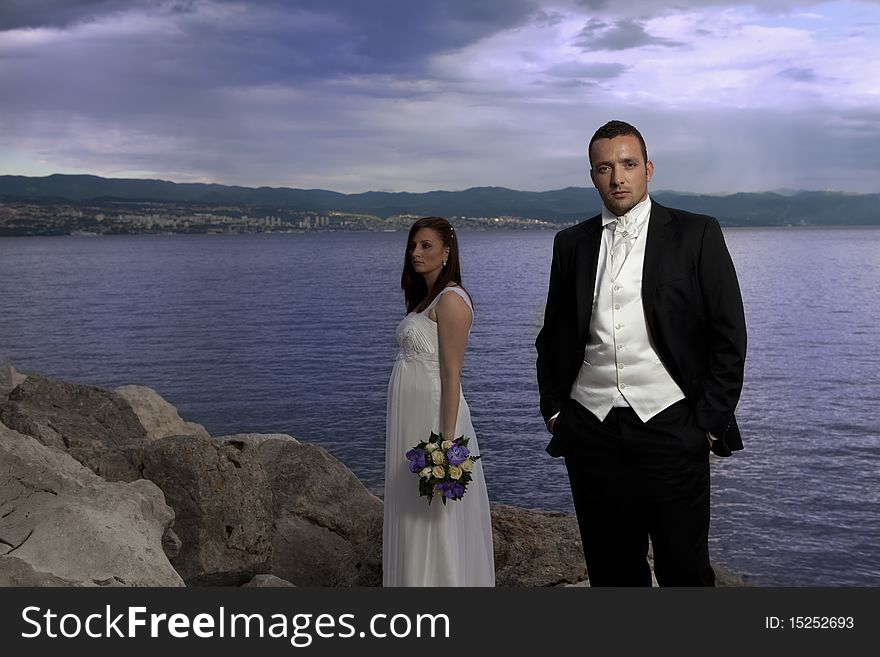 Wedding young nice couple by the sea, on their wedding day. Wedding young nice couple by the sea, on their wedding day