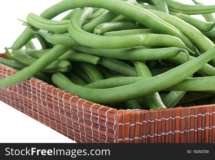 Young green French string bean in pods on a white background. Young green French string bean in pods on a white background.