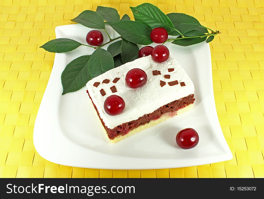 Sweet homemade cake with sour cherries on white plate