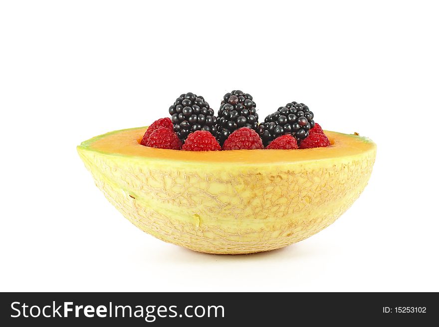 Blackberry and raspberry in melon isolated on white. Blackberry and raspberry in melon isolated on white