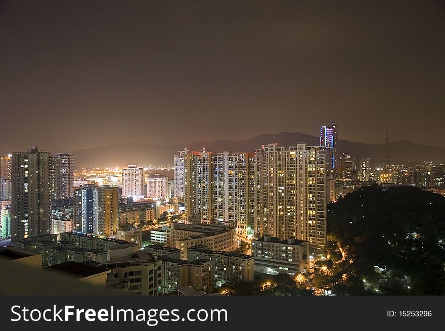 Modern cityscape by night, hundreds of residential buildings in Shenzhen city, China.