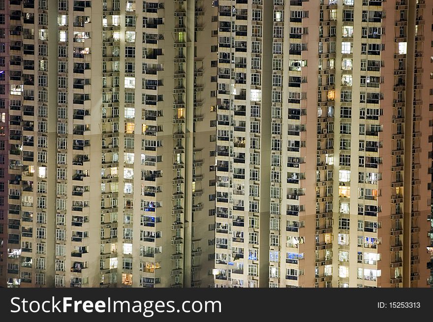 Residential buildings by night, tall skyscrapers in Shenzhen city, China. City with population over 12 millions.