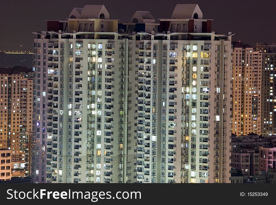 Residential buildings by night, tall skyscrapers in Shenzhen city, China. City with population over 12 millions.